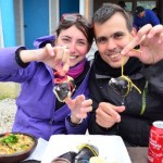 Rachele and Gabor from Surfing the Planet eating sea food in Chiloe